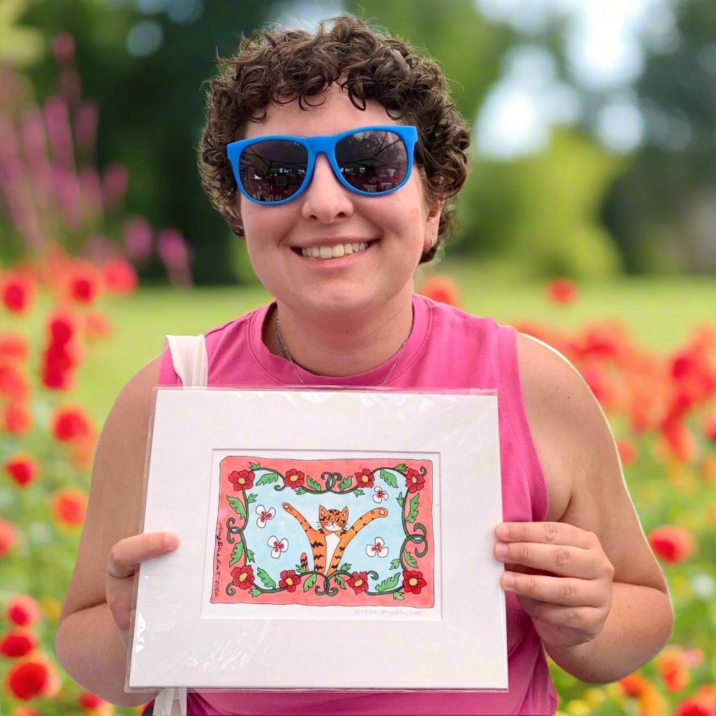 Person holding an art print of Superpussy in the Garden